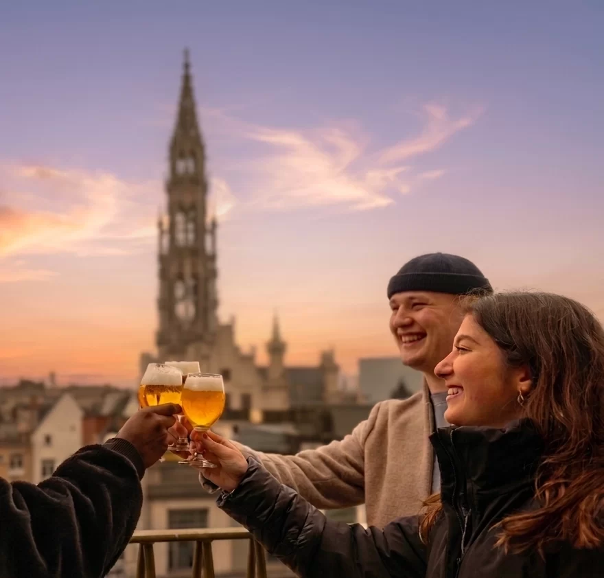 Belgian Beer World Experience &ndash; couple toasting on Brussels rooftop